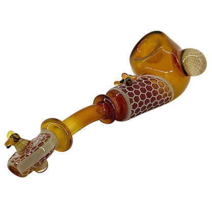 Glass pipe with honeycomb design on a white background.