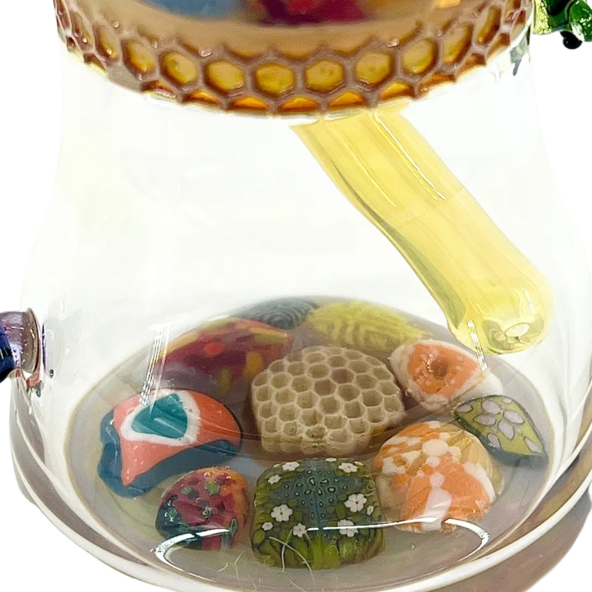 Decorative glass piece with colorful millefiori and a honeycomb design on a white background.