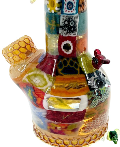 Colorful glass pipe with intricate designs on a white background.