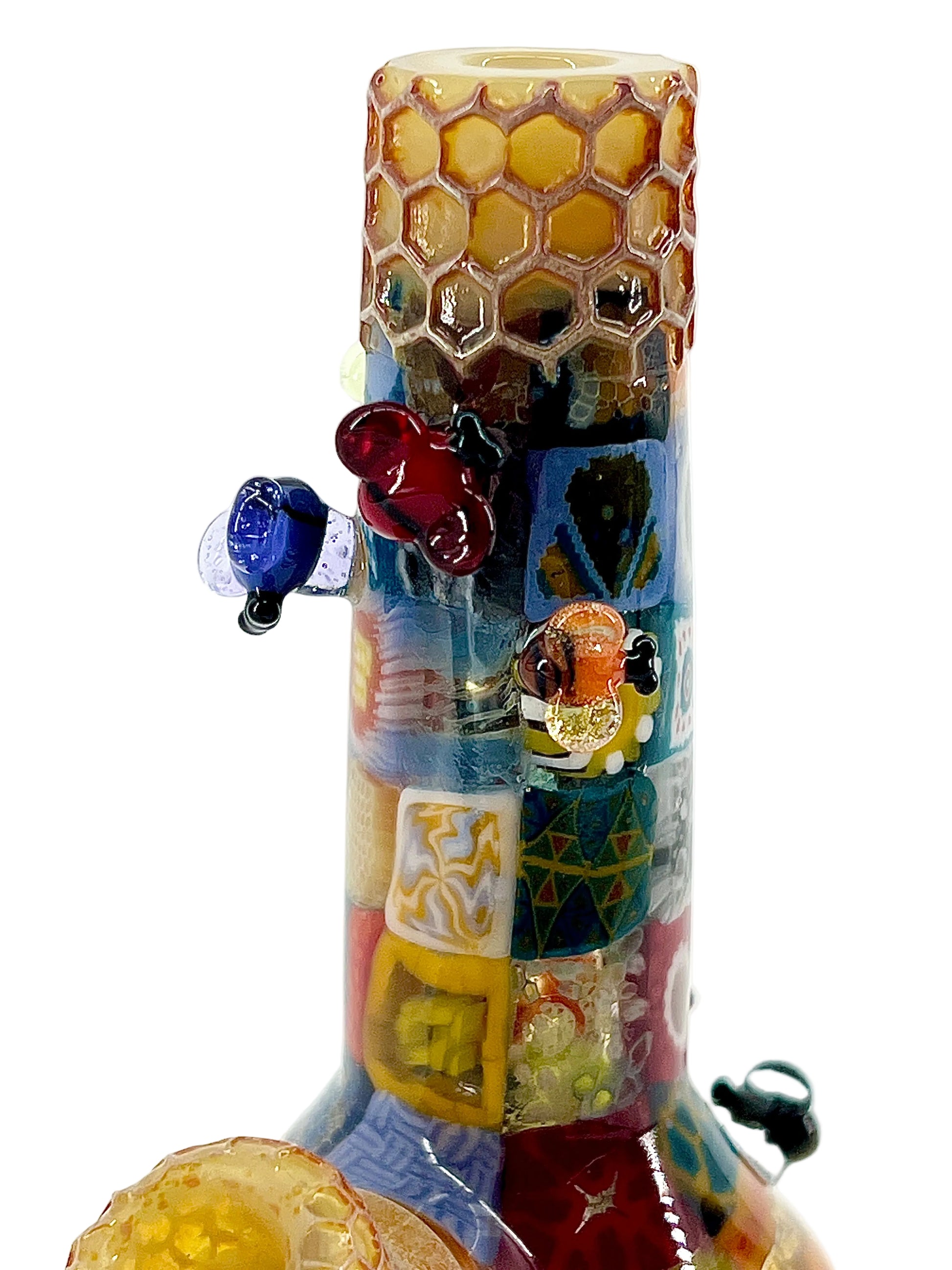 Decorative glass tube with honeycomb design and colorful elements on a white background.
