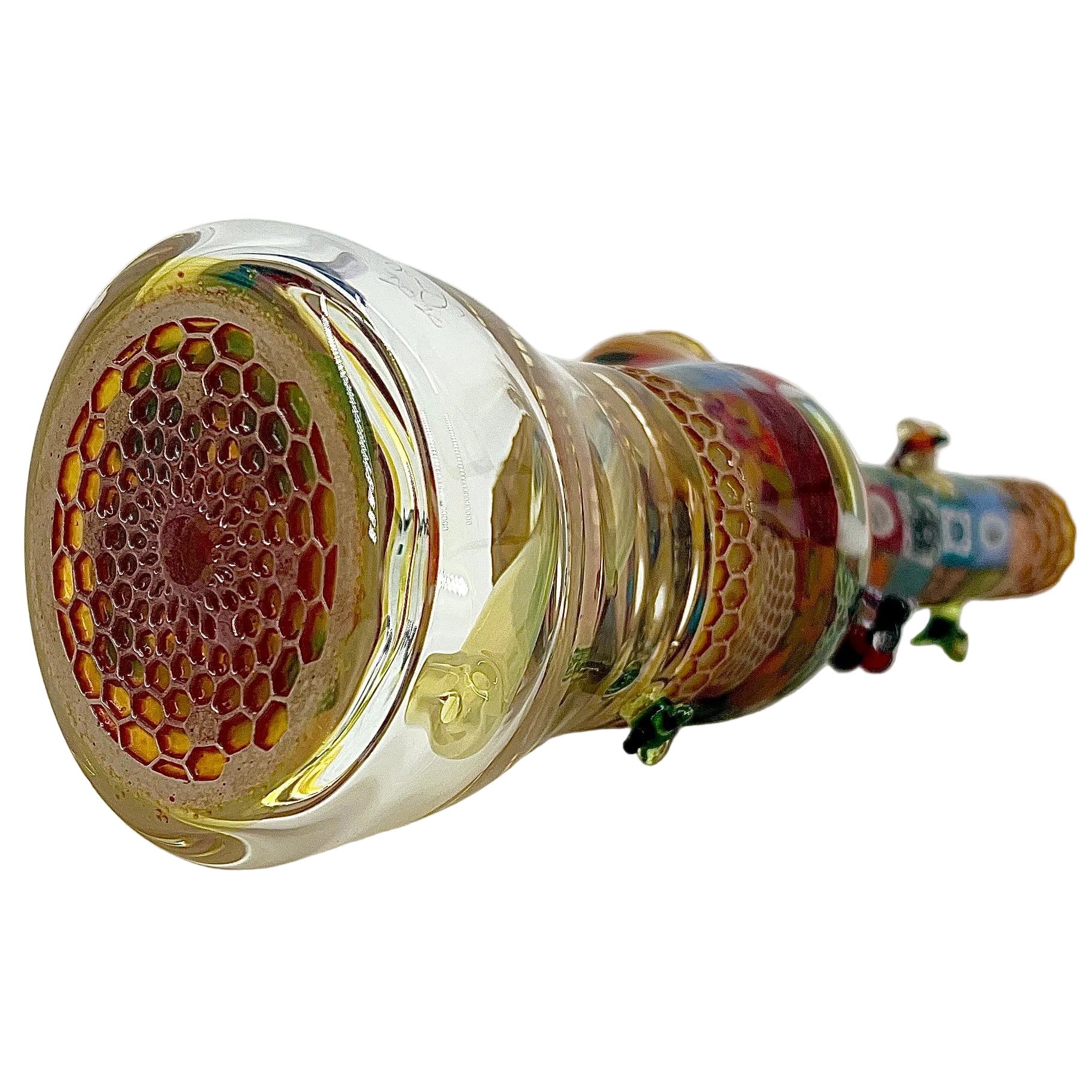Close-up of a glass pipe with intricate designs on a white background.