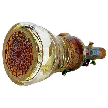 Close-up of a glass pipe with intricate designs on a white background.