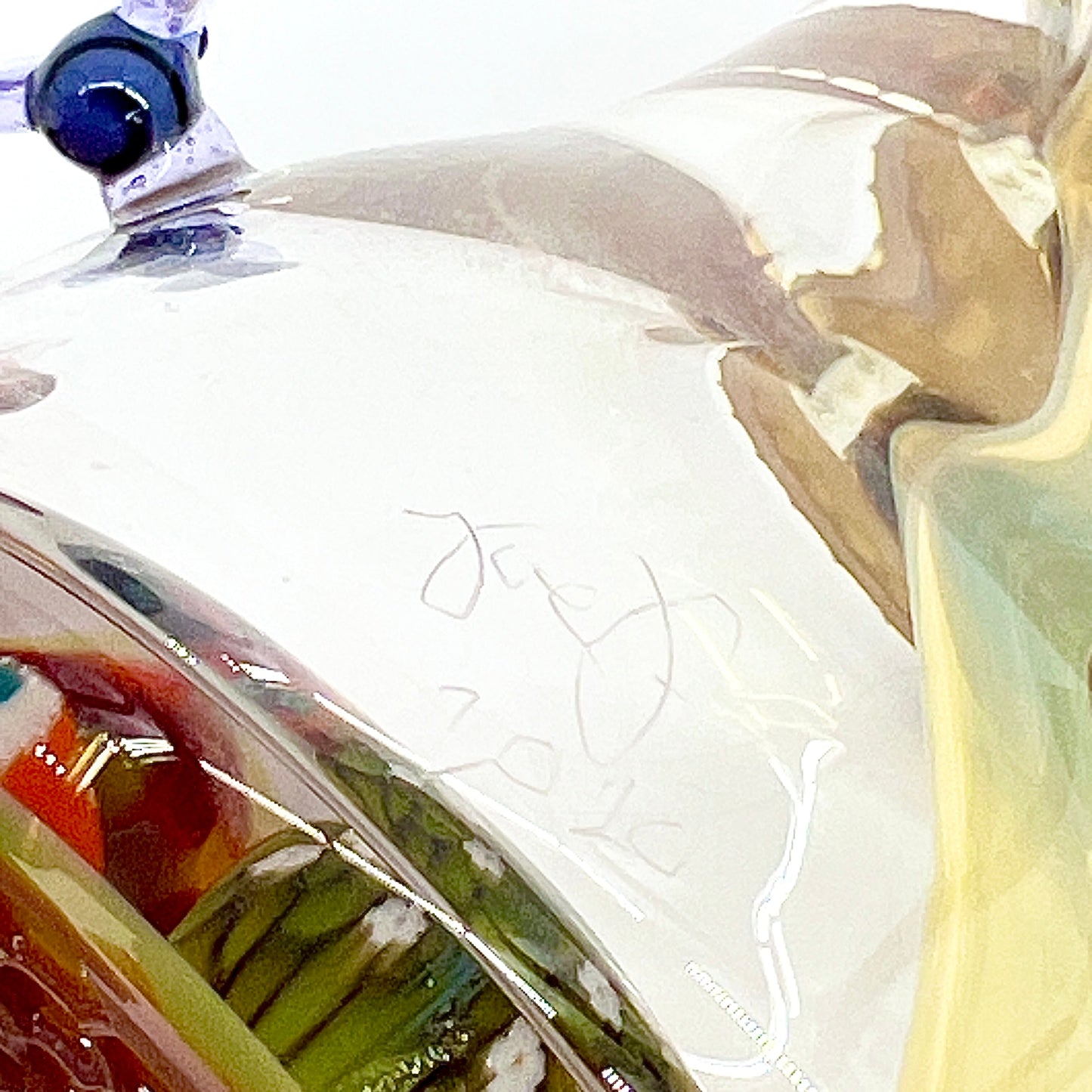 Close-up of a signature on a glass pipe.