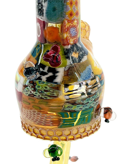 Colorful glass bottle with decorative elements on a white background.