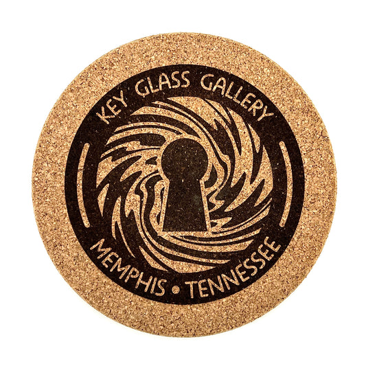 A round cork mat with 'KEY GLASS GALLERY MEMPHIS TENNESSEE' printed in a spiral design.