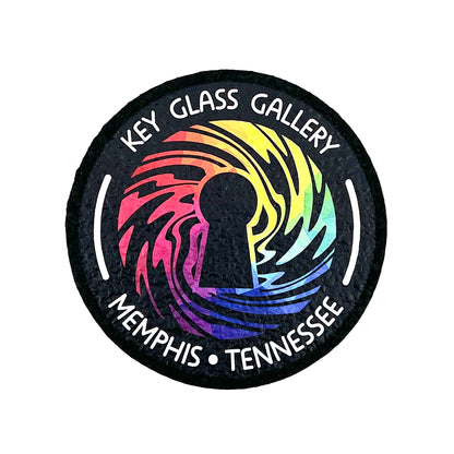 A round mat with a geometric design featuring a key and the text 'Key Glass Gallery Memphis, TN'.
