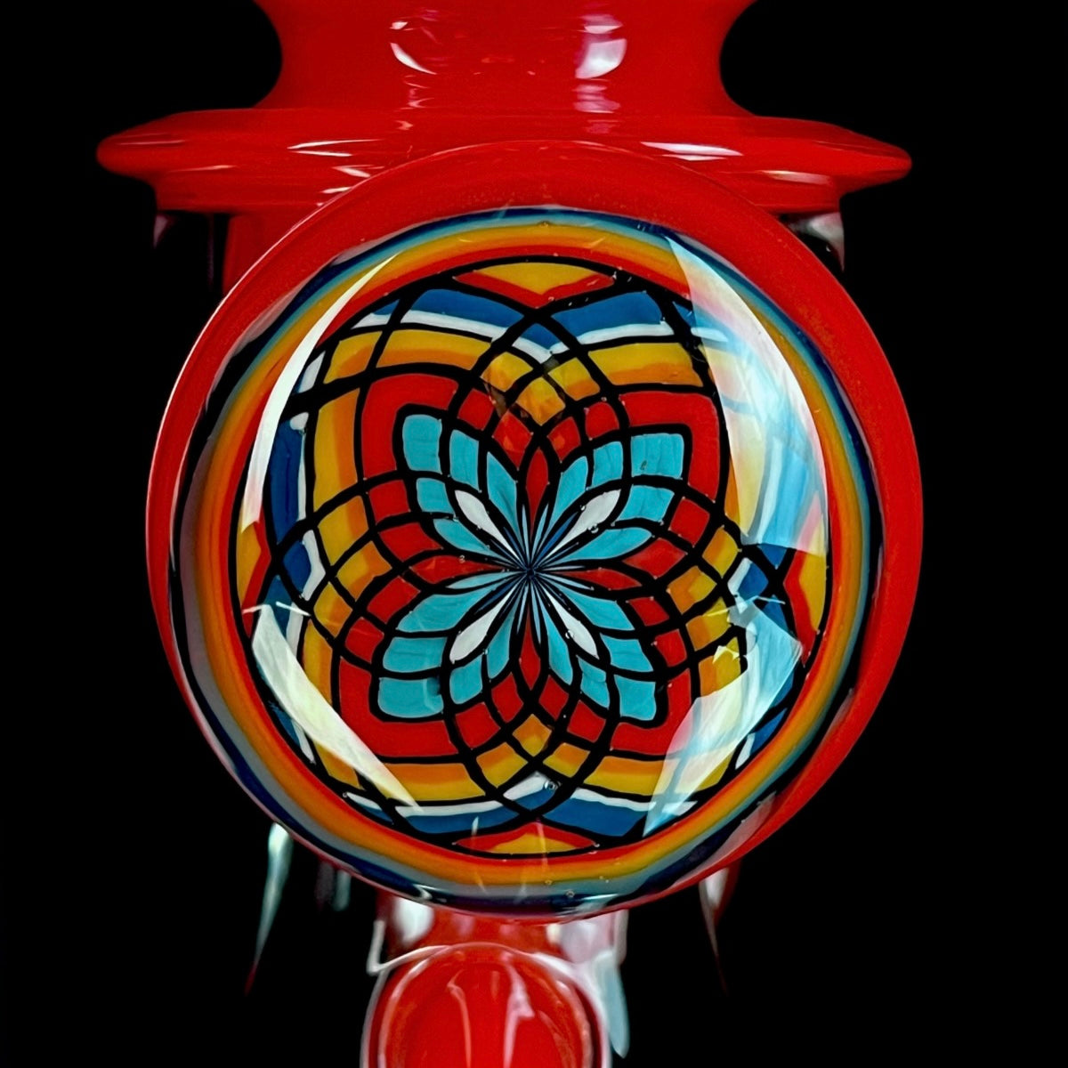 Red and clear glass smoking device with colorful designs on a white background.