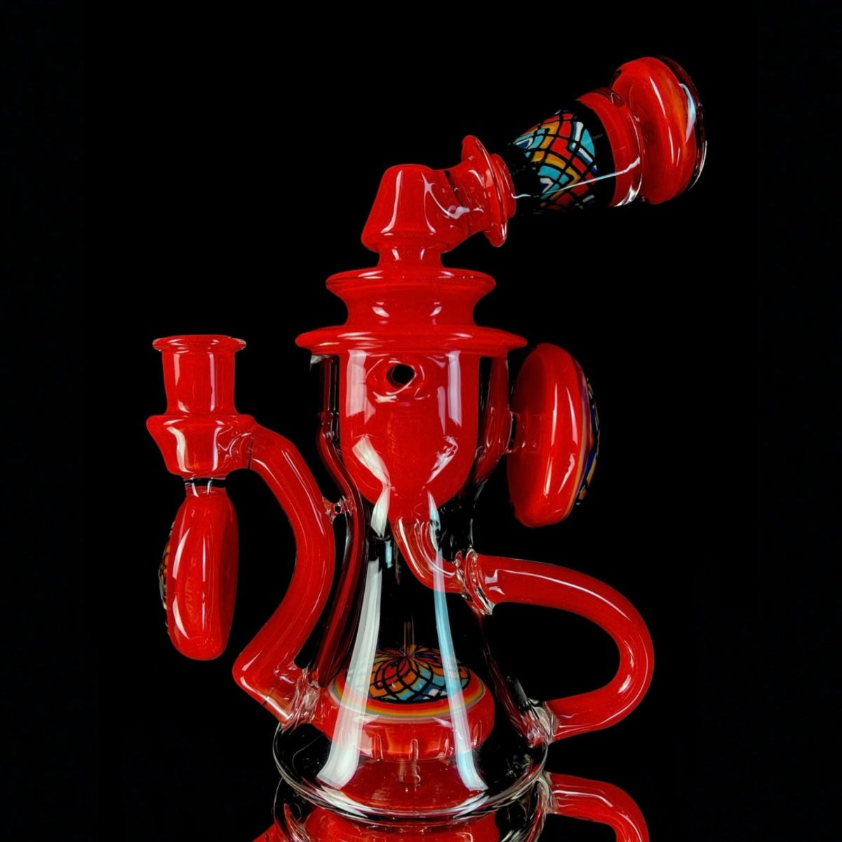 Red and clear glass smoking device with colorful designs on a white background.