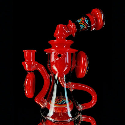 Red and clear glass smoking device with colorful designs on a white background.