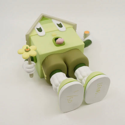 A toy figure of a character resembling a house with eyes, wearing green shorts, a green and white shirt, and green and white shoes, holding a yellow flower.