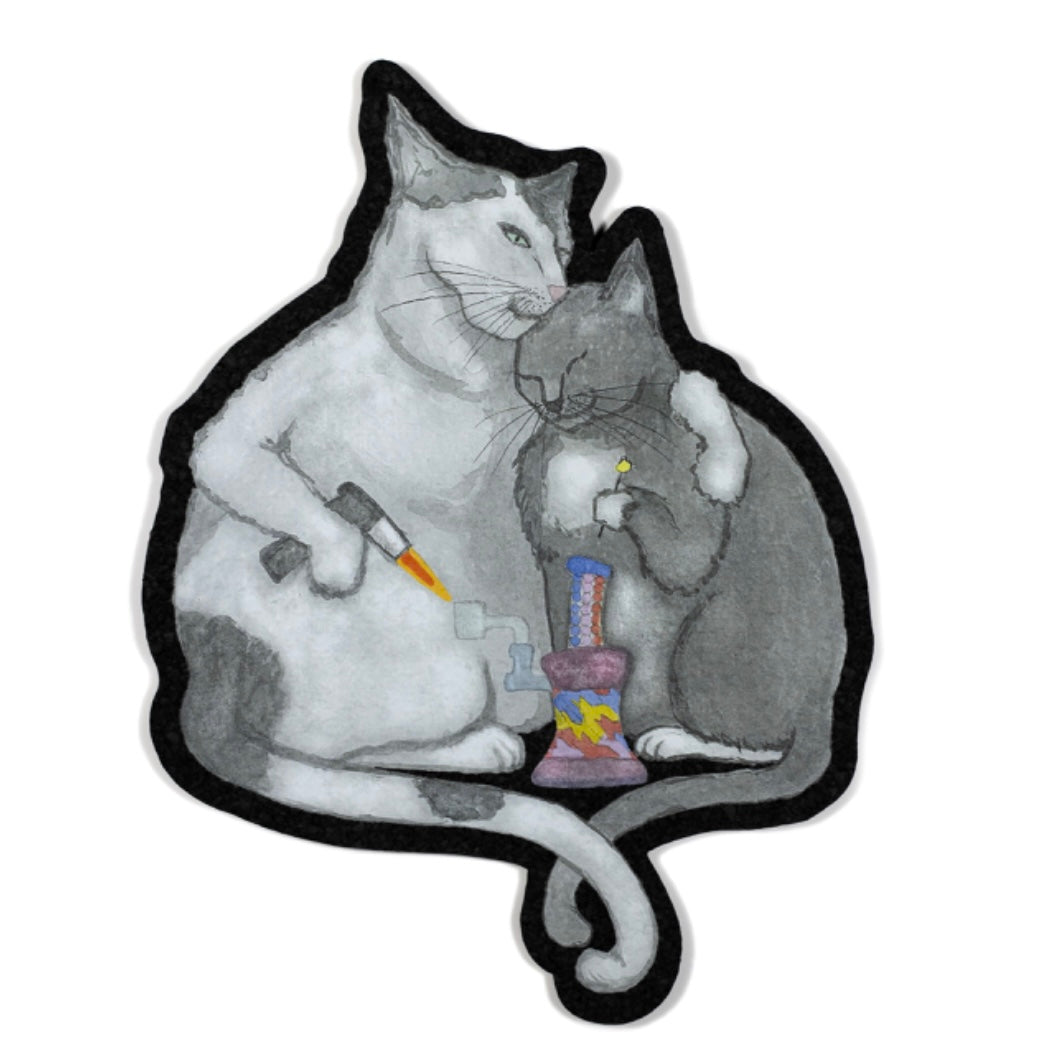 A decorative moodmat featuring a design with two cartoon cats and a colorful object.