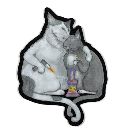 A decorative moodmat featuring a design with two cartoon cats and a colorful object.