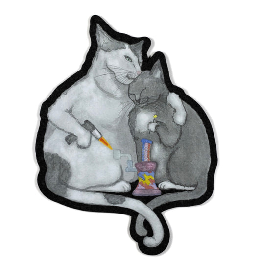 A decorative moodmat featuring a design with two cartoon cats and a colorful object.