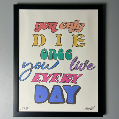 A colorful print with the text 'you only DIE once you live EVERY DAY' in various fonts and colors on a white background, indicating a motivational or inspirational message.