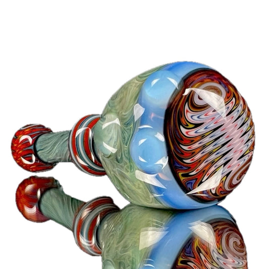A colorful glass spoon pipe with swirls of blue, green, and red, featuring a large bowl and hand-pulled lined tubing.