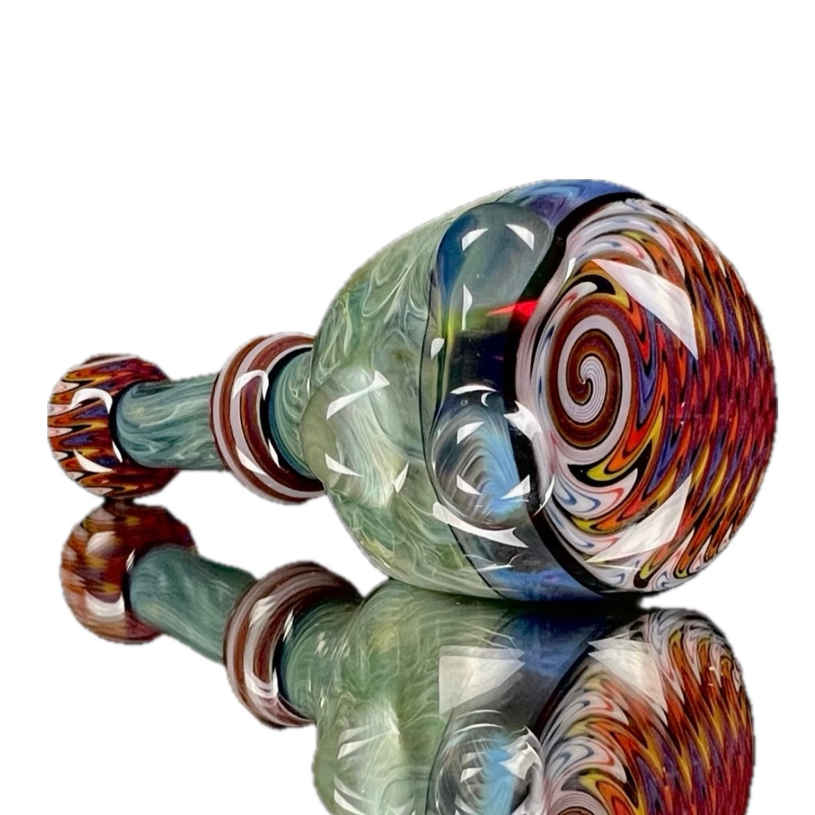 A hand-blown glass pipe with 'Amazon Night' color accented by 'Light Yellow' over 'Pomegranate' with hand-pulled lined tubing.