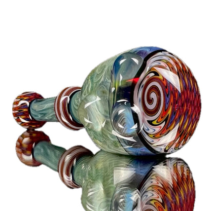 A hand-blown glass pipe with 'Amazon Night' color accented by 'Light Yellow' over 'Pomegranate' with hand-pulled lined tubing.