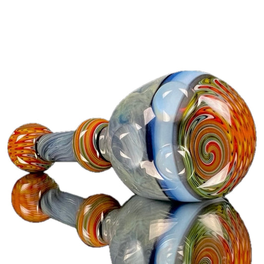 A colorful glass spoon pipe with swirl patterns and a large bowl.