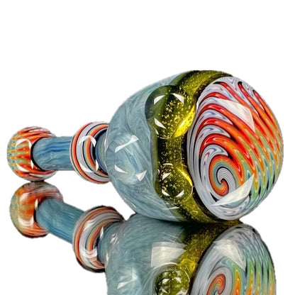A colorful glass spoon pipe with blue, red, and green swirls and accents.