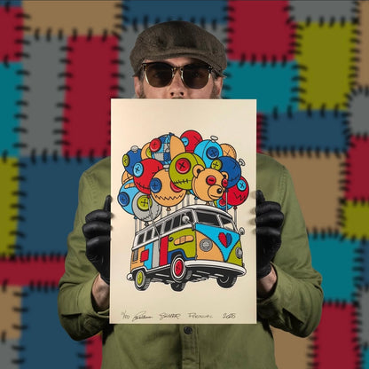 A person holding a colorful screenprint of a bus with a whimsical character on it, in front of a multi-colored background.