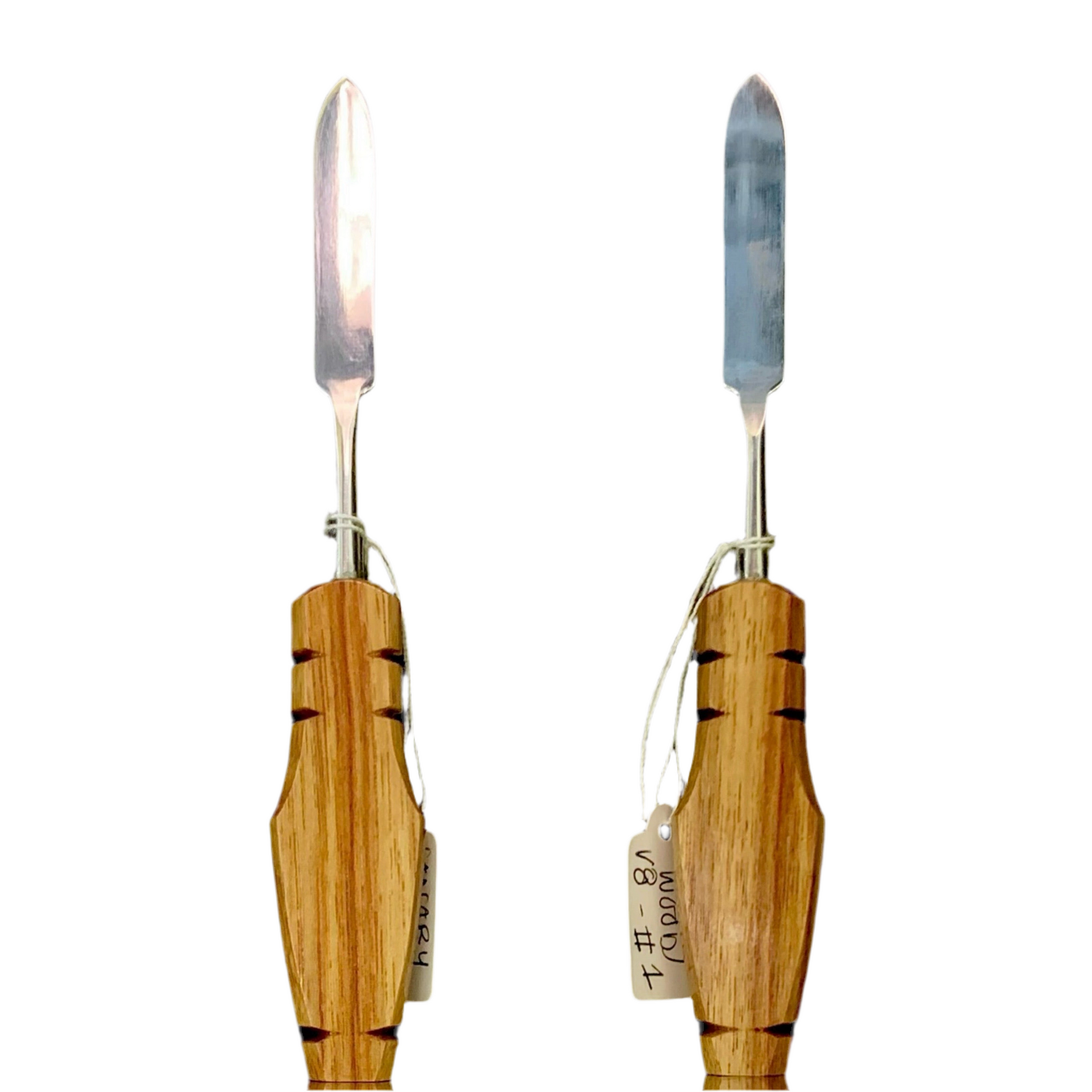 Two wooden handled tools with metal blades, one with a flat surface and the other with a curved surface, each having a small tag attached.
