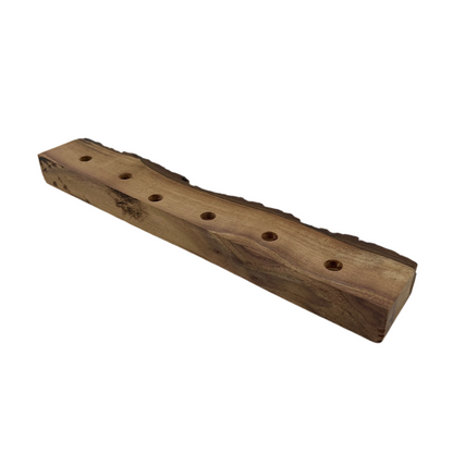 Wooden block with holes on a white background.