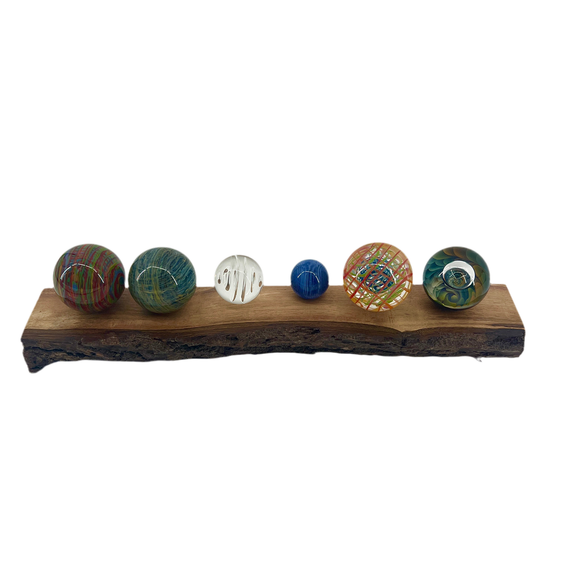 Set of colorful marbles on a wooden stand with a white background.