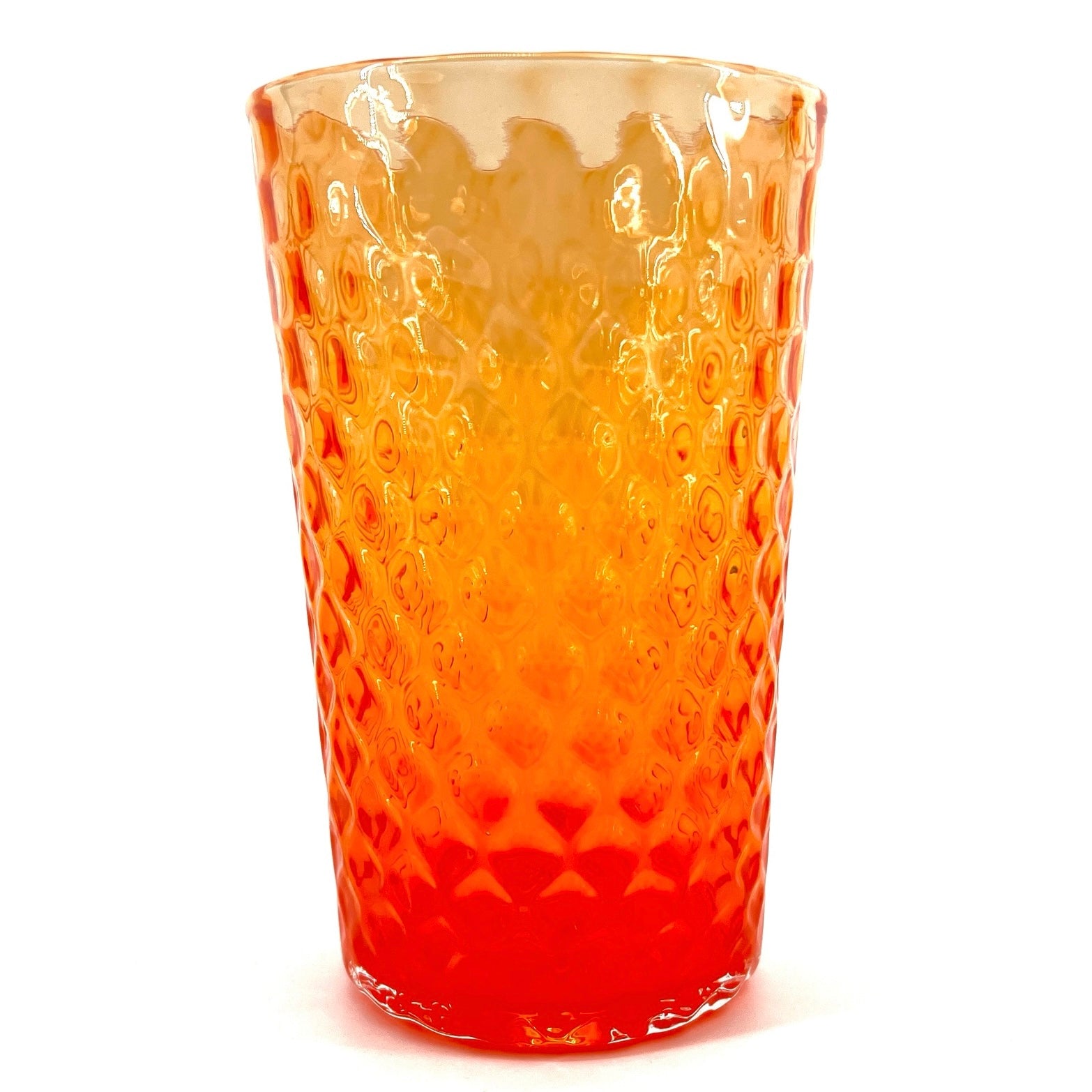 A hand-blown glass with an orange color and a textured surface, crafted by Xander D’Ambrosio.