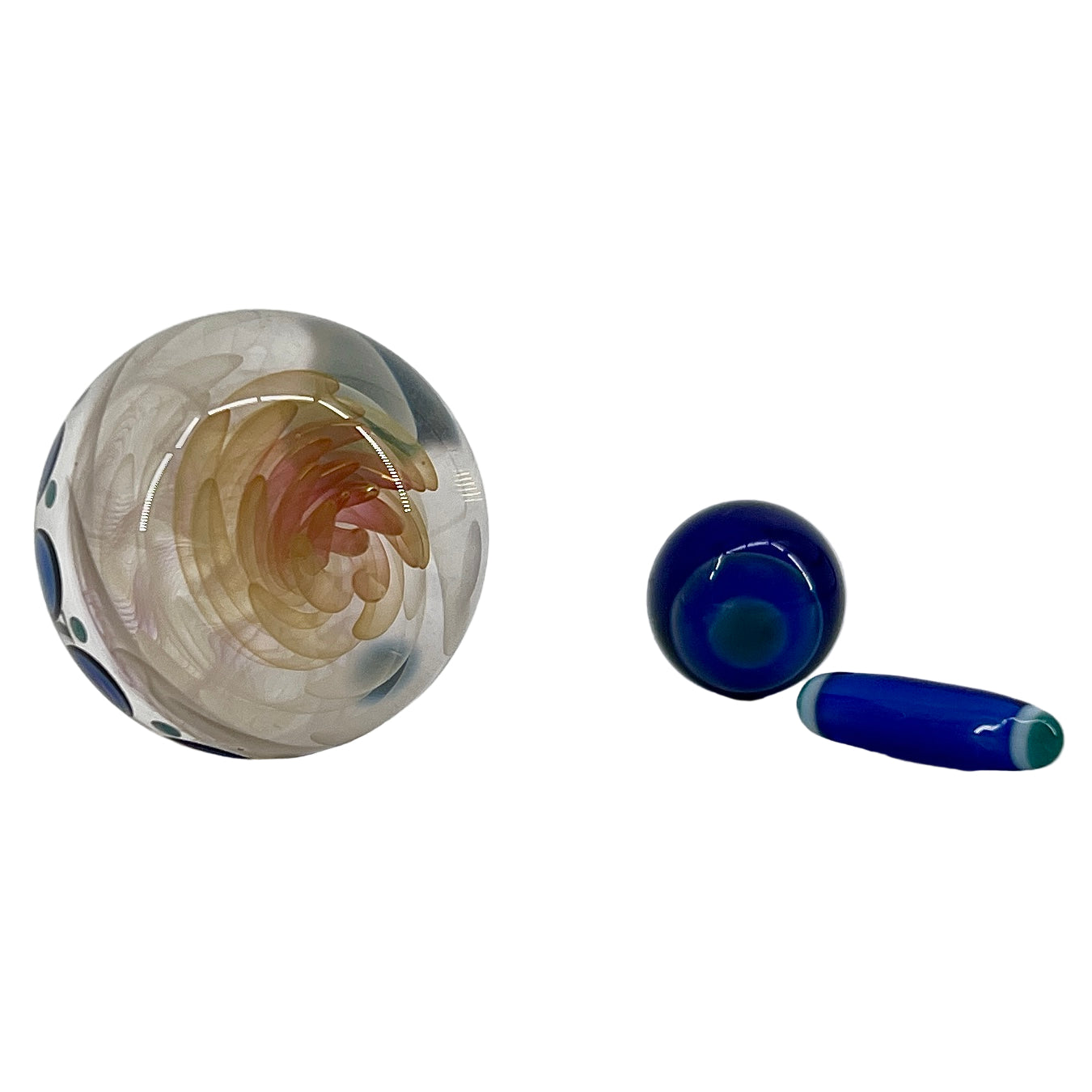 Two glass marbles and a glass pillar on a white background.
