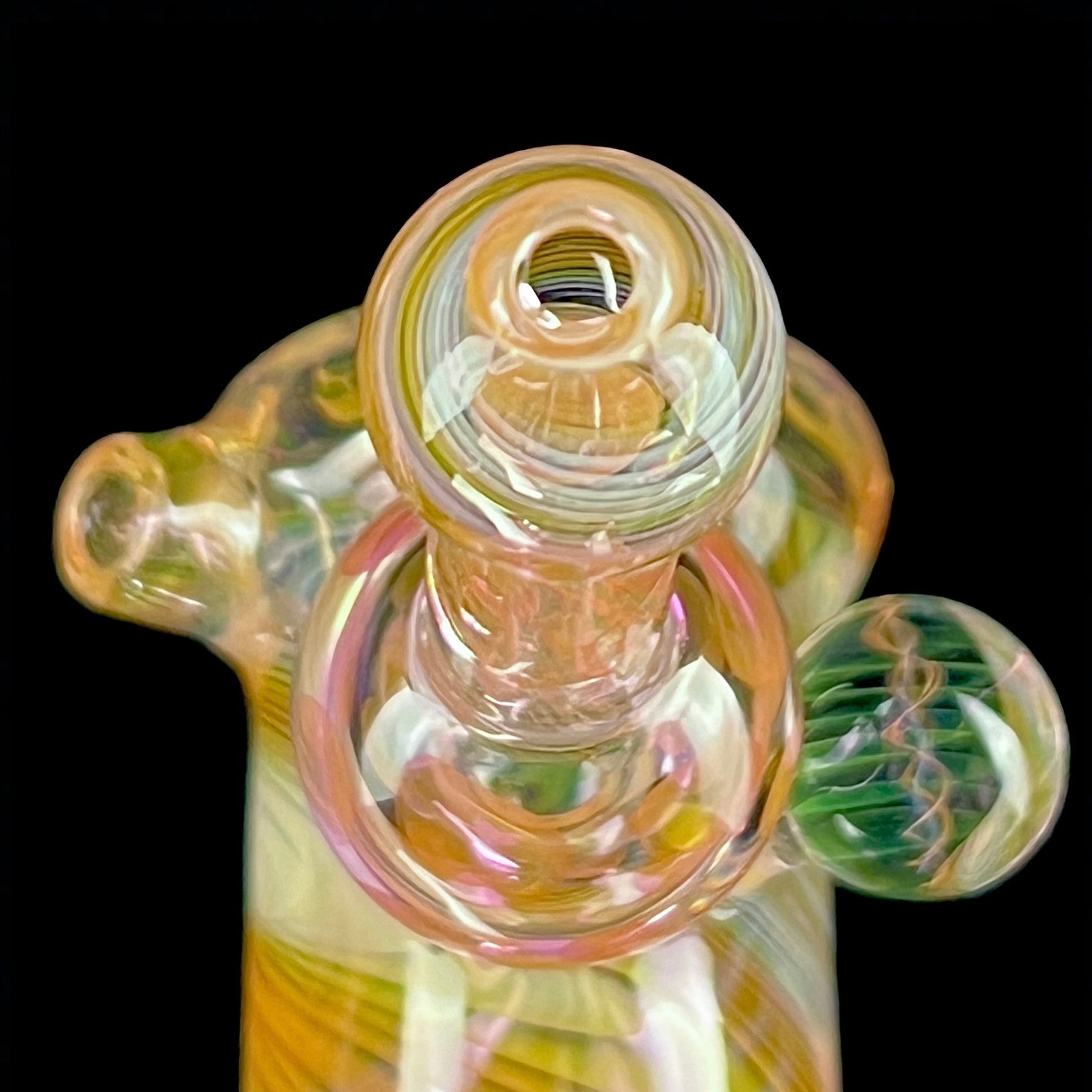 A multicolored glass hammer-style pipe with intricate patterns and a round bowl.