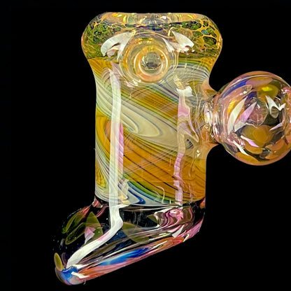 A multicolored glass hammer-style pipe with intricate patterns and a round bowl.