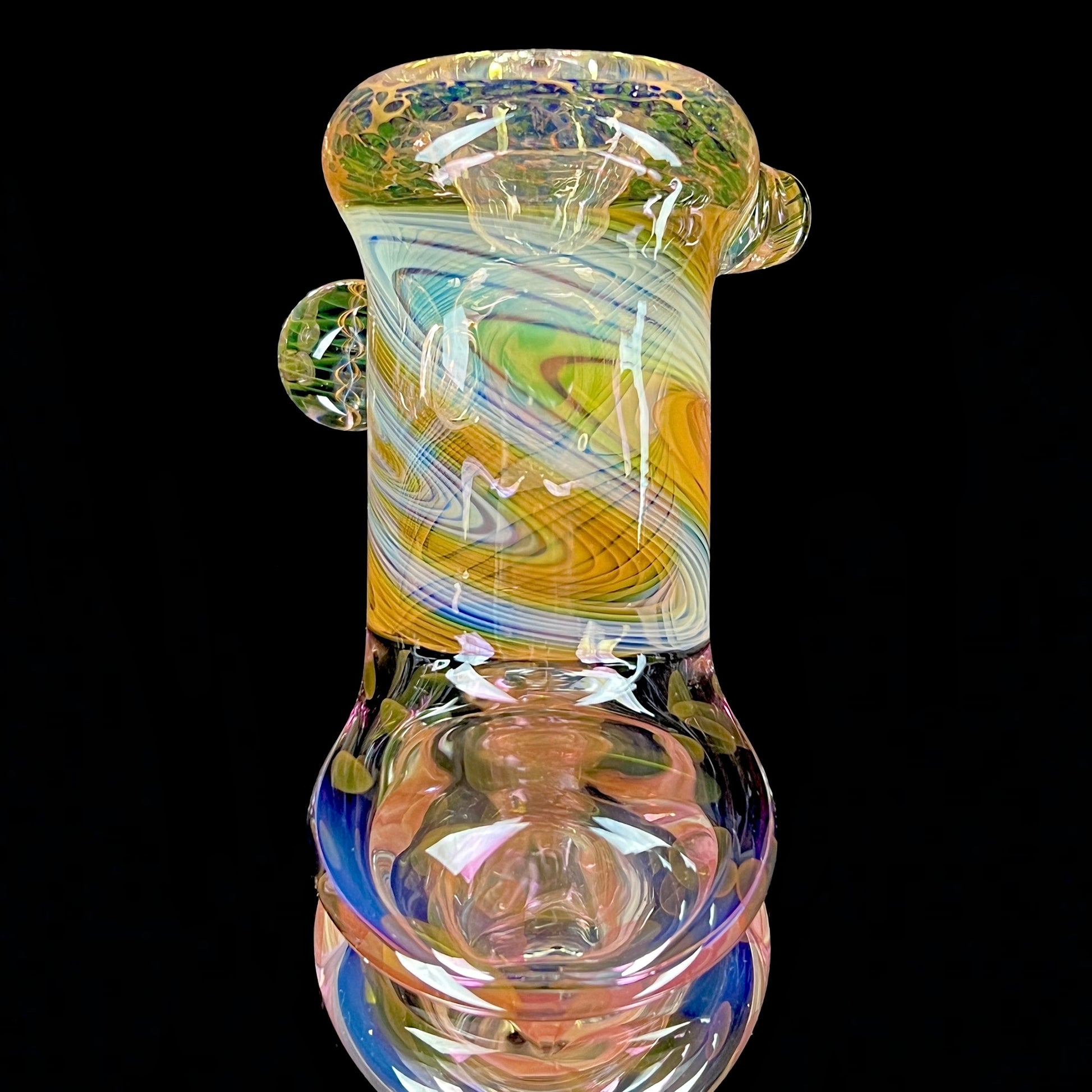 A multicolored glass hammer-style pipe with intricate patterns and a round bowl.