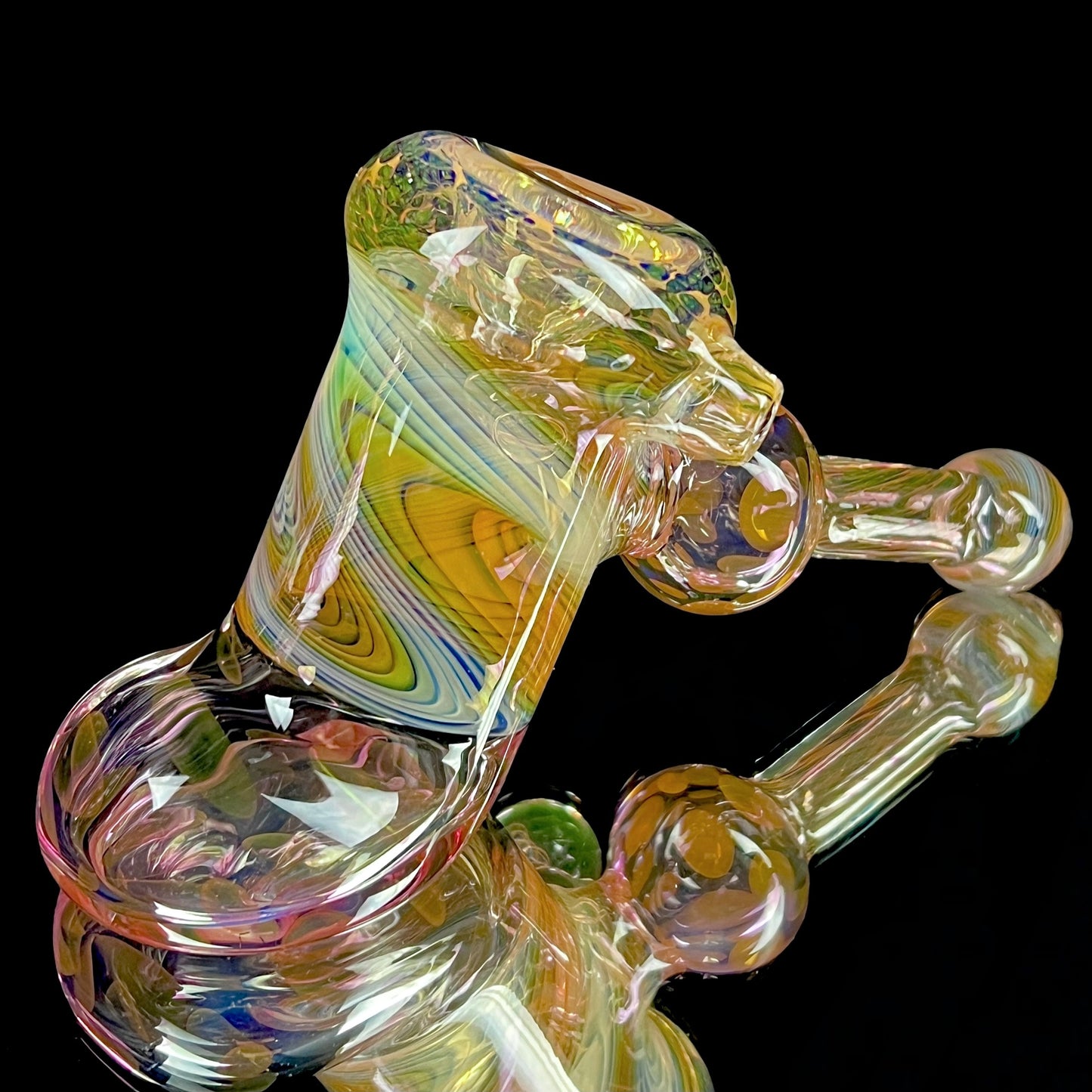 A multicolored glass hammer-style pipe with intricate patterns and a round bowl.