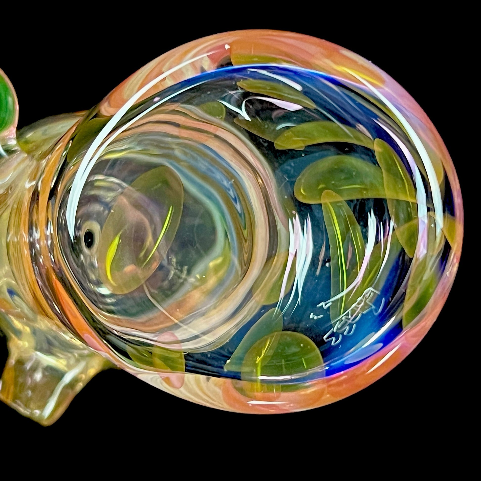 A close up of a multicolored glass hammer-style pipe with intricate patterns and a round bowl.