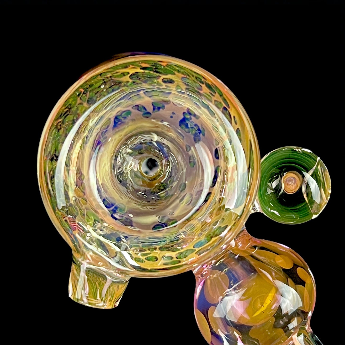 A bowl shot of a multicolored glass hammer-style pipe with intricate patterns and a round bowl.