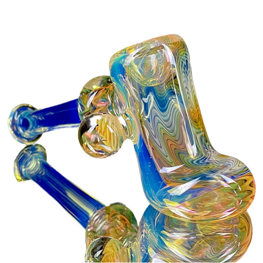 A colorful glass hammer-shaped piece with blue, gold, and silver fume patterns.