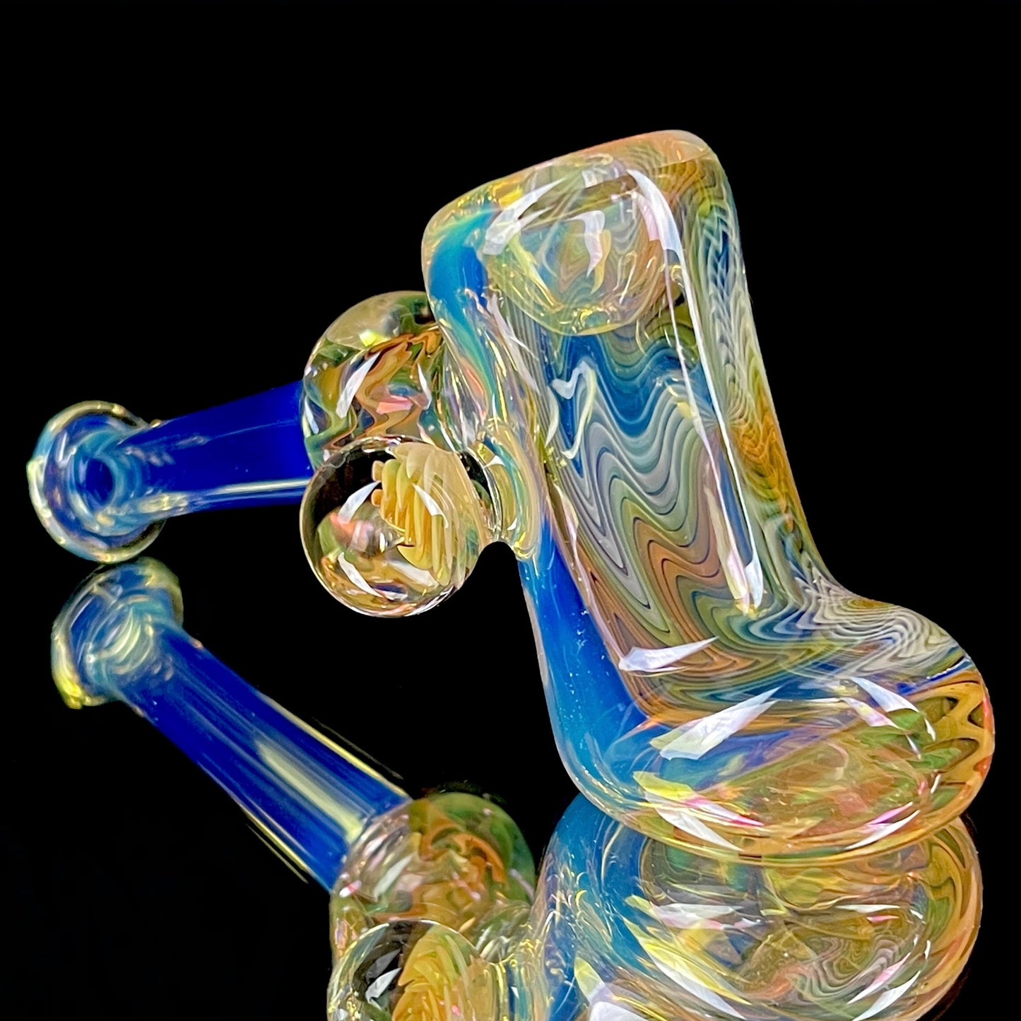 A smoking pipe with a gold and silver fume color, approximately 5.25” long, with a medium-pack bowl, signed and dated on the bottom.