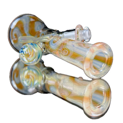 A colorful glass mini tube with a fumed design, featuring a clear body and a multicolored neck.