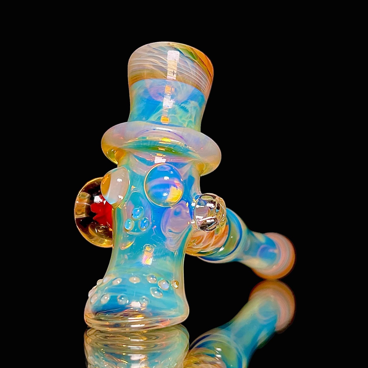 Colorful glass pipe with iridescent finish on a black background.