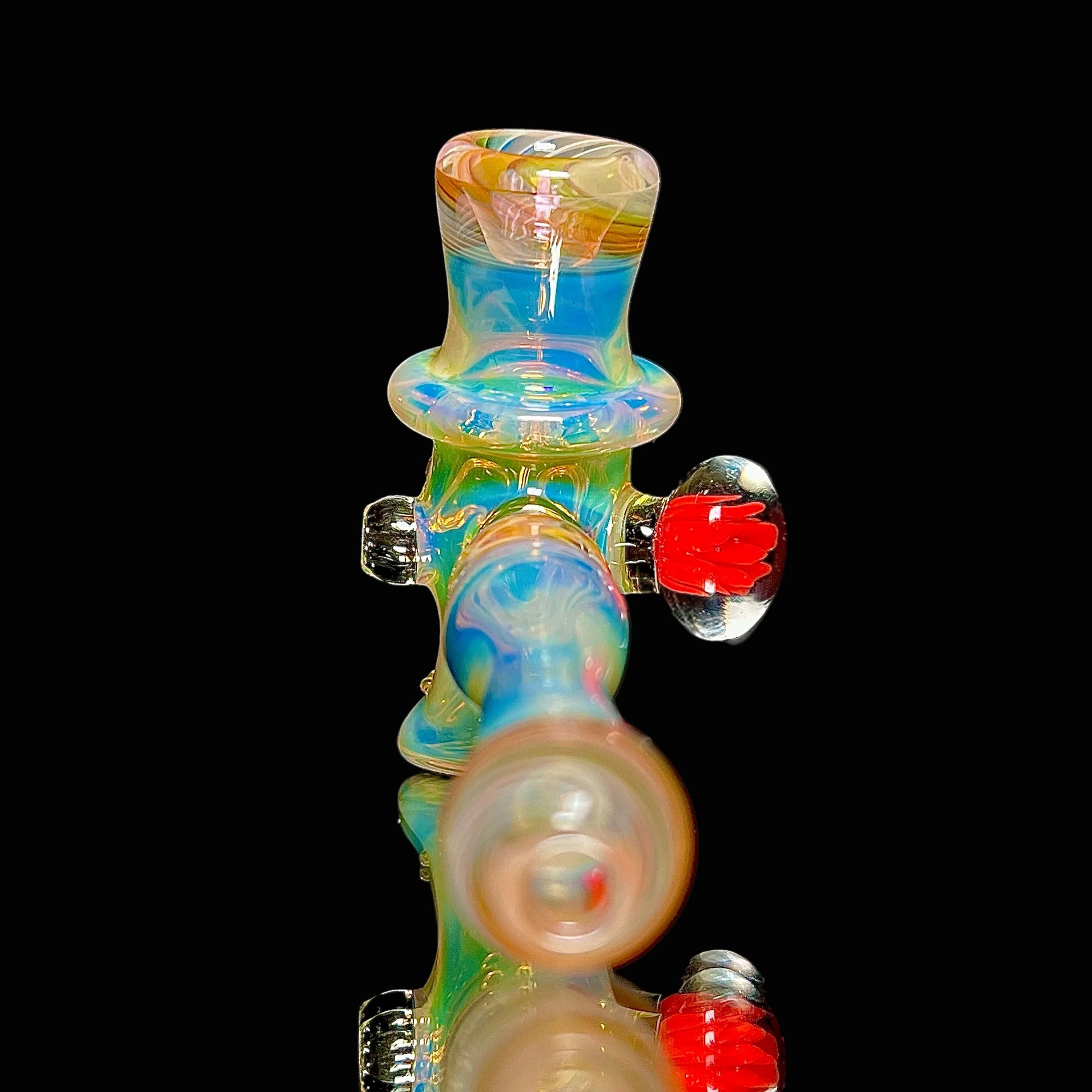 Colorful glass smoking accessory on a black background.