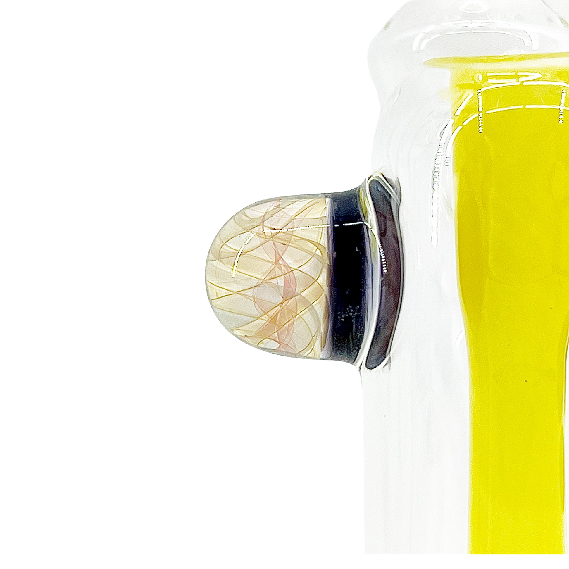 Close up of a fume attachment on a clear bubbler with yellow accents on a white background.