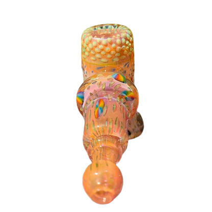 Decorative glass object with multicolored patterns on a white background.
