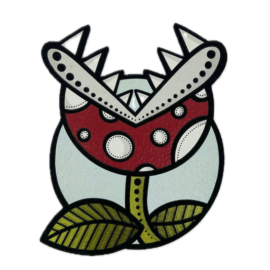 A decorative mood mat featuring a stylized design of a mushroom with red and white spots on a green and white background, with a leaf motif at the bottom.