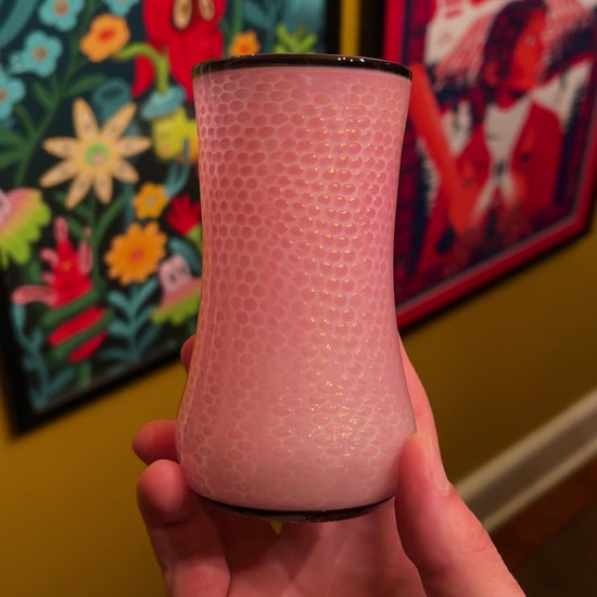 Video of a pink cup in a hand showing all sides of the cup.