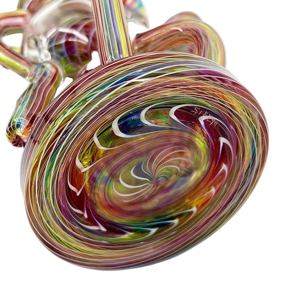 Multicolored glass object with swirling pattern on a white background