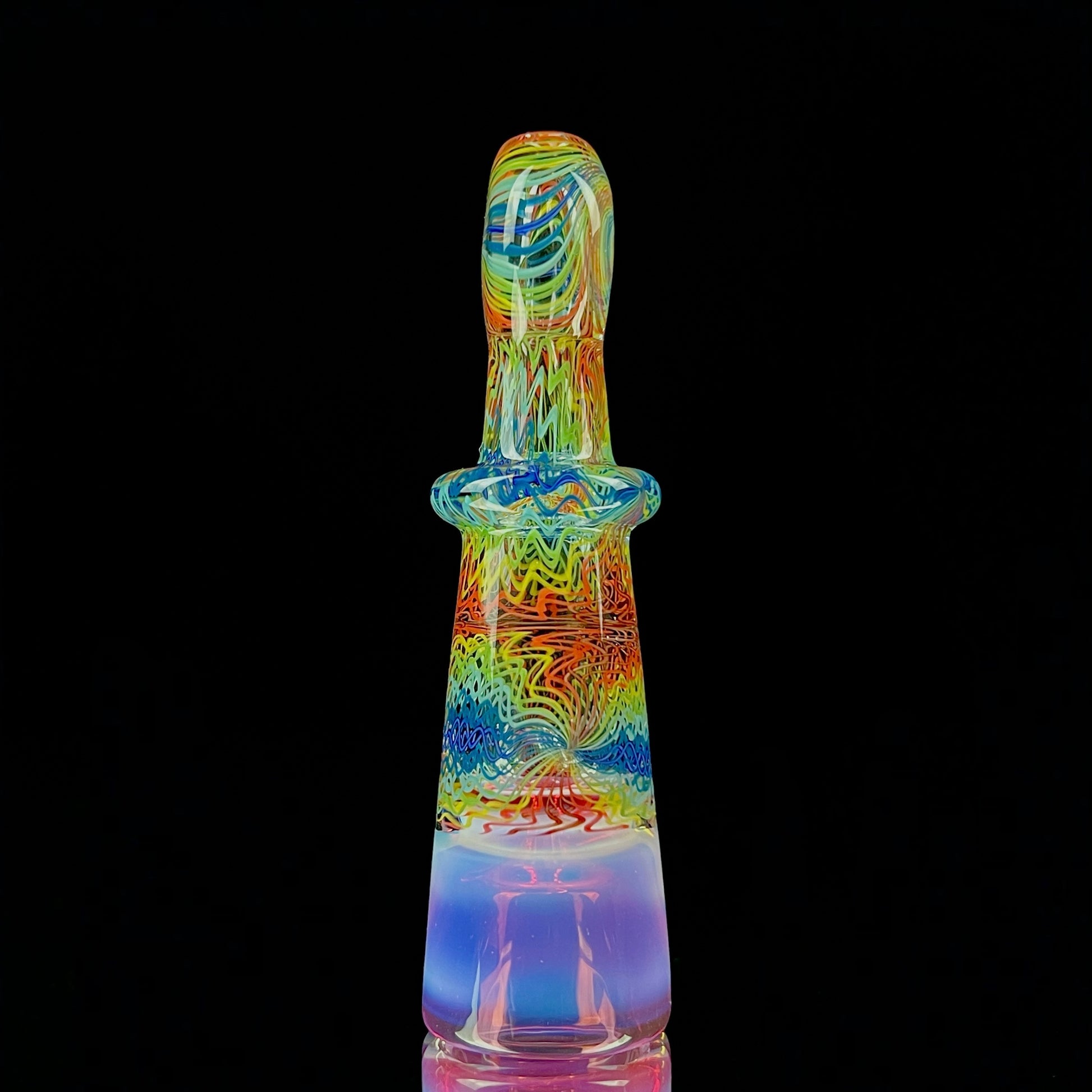 A multicolored glass piece with an intricate pattern, featuring a bowl on the bottom and a Gold Ruby over Moonstone lip.