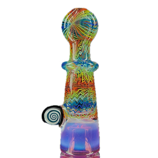 A multicolored glass piece with an intricate pattern, featuring a bowl on the bottom and a Gold Ruby over Moonstone lip.