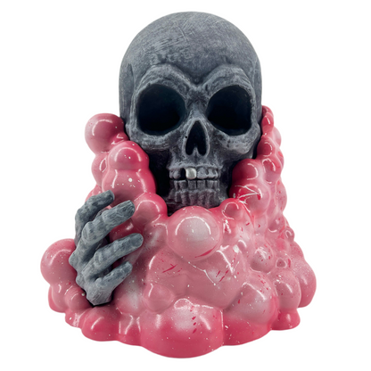 Skull with pink goo and gray hand on a white background.