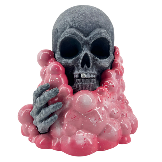 Skull with pink goo and gray hand on a white background.