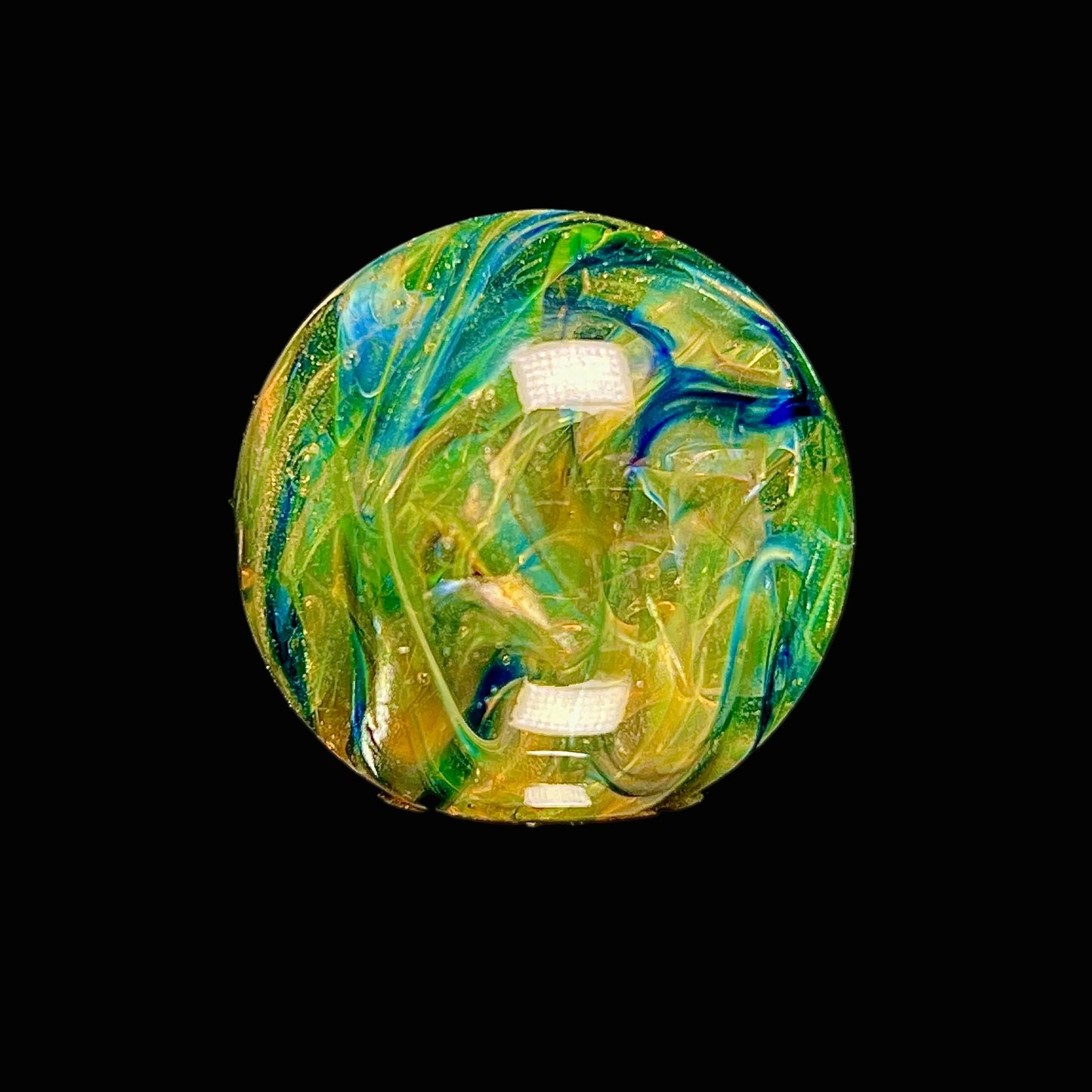 Colorful glass marble with artistic design on a black background